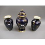 Garniture of three 19th Century Davenport vases with floral gilded decoration on dark blue ground (