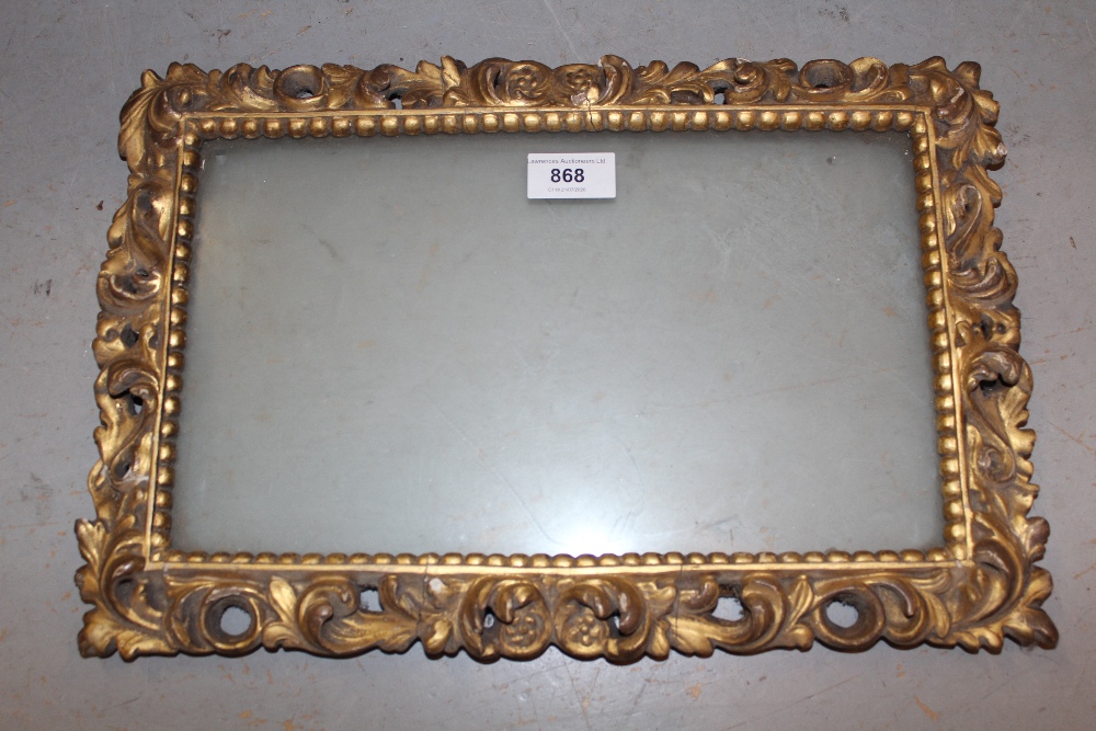 19th Century Italian carved giltwood picture frame having pierced C-scroll decoration, aperture size