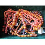 Two amber bead necklaces, two coral necklaces and another necklace In order of photographs -