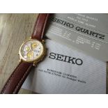 Seiko 1990's World Time quartz wristwatch with brown leather strap and papers