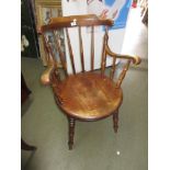 Early 20th Century beechwood elbow chair with turned rail back above circular panelled seat raised