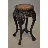 19th Century Chinese carved hardwood vase stand with a flecked marble inset top above a pierced