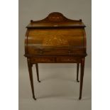 Edwardian rosewood marquetry inlaid cylinder bureau with a fitted interior above two frieze