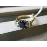 Unmarked yellow metal sapphire and diamond ring, the central rectangular sapphire flanked by two