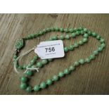 Graduated green jade bead necklace with silver clasp Good condition. No signs of damage or repair.