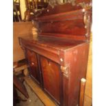 Victorian mahogany chiffonier with a carved shelf back above a moulded drawer and two panelled doors