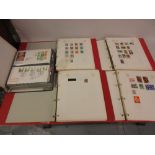 Four red folders containing G.B. and other World stamps, together with an album of First Day covers