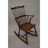 Early 19th Century Windsor comb back rocking chair with a moulded panel seat raised on turned