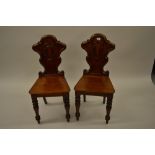 Pair of good quality Victorian mahogany carved shield back hall chairs with panel seats raised on