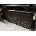 Late 17th or early 18th Century oak mule chest with a hinged lid above a three panel front and two