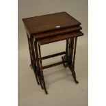 Nest of three William IV rectangular rosewood occasional tables on twin turned end supports with