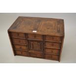 18th Century Continental marquetry inlaid table cabinet with an arrangement of drawers and a door