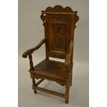 19th Century oak Wainscot chair with a carved panelled back on turned supports with stretchers