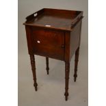 Early 19th Century mahogany bedside cabinet with a tray top above a single door on ring turned