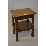 Small good quality reproduction oak two tier occasional table with pull-out slide on baluster turned