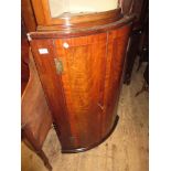 George III mahogany crossbanded and line inlaid bow front hanging corner cabinet
