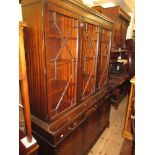 Reproduction mahogany bookcase, the moulded dentil cornice above three astragal glazed doors, the