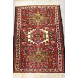 Small Karaja rug with triple medallion and multiple borders on wine ground, 38ins x 26ins together