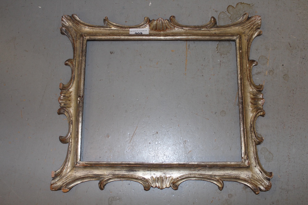 Carved giltwood picture frame having arched top, together with a carved and silvered frame,