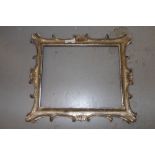Carved giltwood picture frame having arched top, together with a carved and silvered frame,