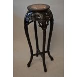 19th Century Chinese carved hardwood vase stand with a flecked marble inset top above a pierced