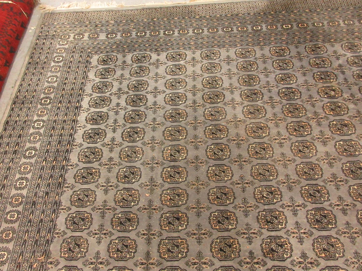 Pakistan carpet of Bokhara design on a blue grey ground, 12ft x 9ft approximately - Image 2 of 2