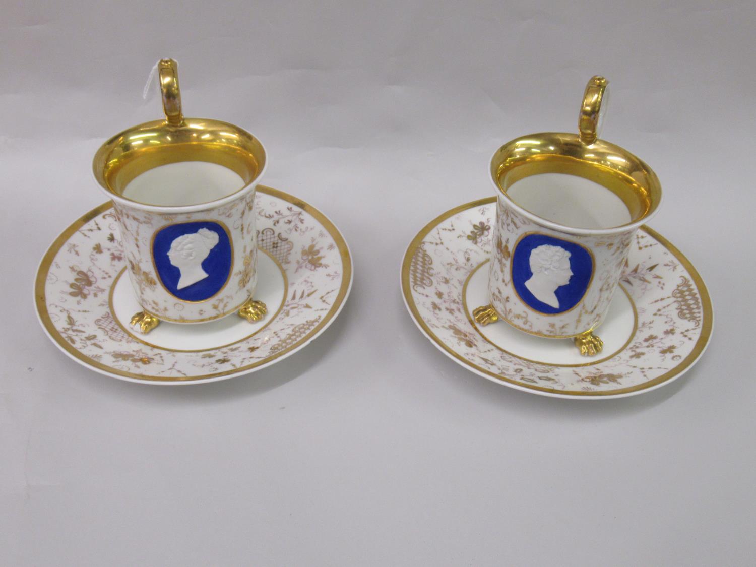 Pair of 19th Century French porcelain cabinet cups and saucers in Empire style decorated with male