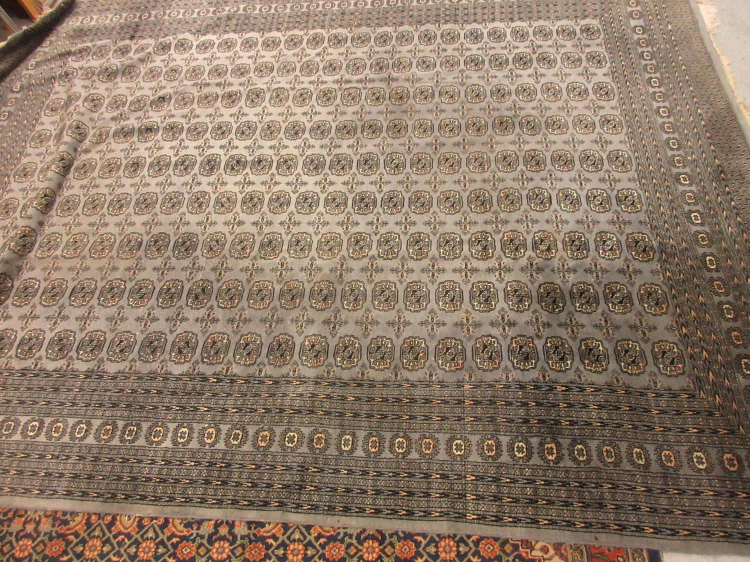 Pakistan carpet of Bokhara design on a blue grey ground, 12ft x 9ft approximately