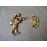 9ct Gold chimney sweep pendant together with a yellow metal pendant in the form of a scarab