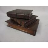 Graduated set of three small mahogany puzzle boxes in the form of books largest measures 5.5in x 4in