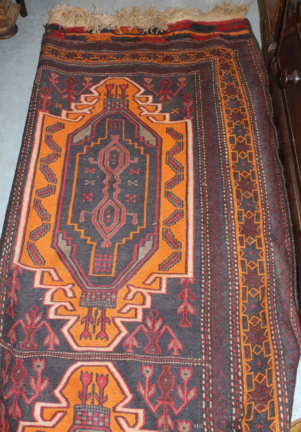 Soumak rug having four hooked medallions on a blue ground with multiple borders, 5ft x 9ft