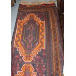 Soumak rug having four hooked medallions on a blue ground with multiple borders, 5ft x 9ft