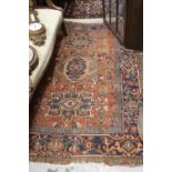 Karaja rug with a triple medallion design on a brick red ground with borders, 6ft x 4ft 6ins