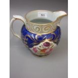 19th Century English Pearlware jug painted with panels of summer flowers on a blue and gilt