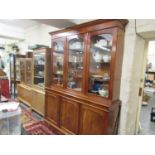 Victorian mahogany library bookcase, the moulded cornice above three glazed doors, the base with