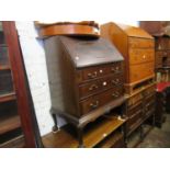 Mahogany bureau with fall front above three drawers on shell carved cabriole claw and ball supports