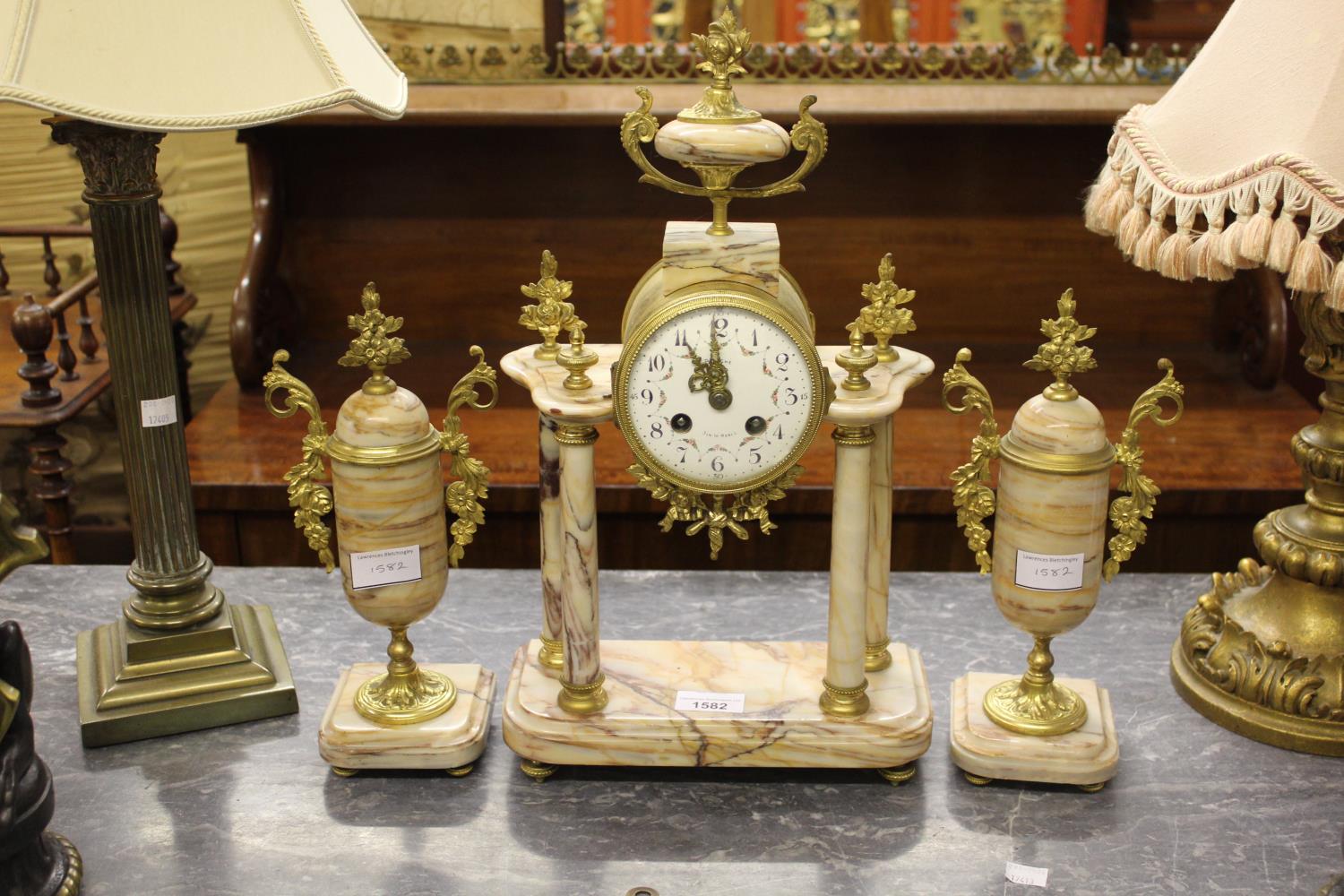 French ormolu and marble three piece clock garniture, the enamel dial with Arabic numerals inscribed