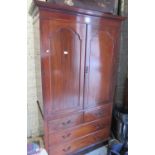 Early 20th Century mahogany linen press, the moulded cornice above a pair of arched panel doors, two