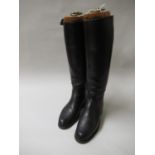 Pair of black leather riding boots with trees having gilt ring pull handle and label for Alan