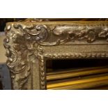 Large good quality antique gilt picture frame with relief moulded stylised scroll work design, 36ins