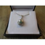 18ct White gold emerald and diamond pendant on a silver chain