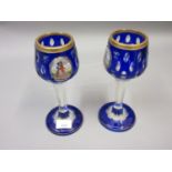 Pair of heavy 19th Century Continental blue overlay glass goblets having panels of hand painted