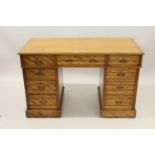 Late 19th Century satin birch twin pedestal desk, the moulded top above nine drawers, stamped