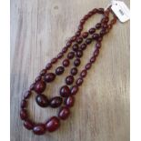 Cherry amber graduated bead necklace together with another similar