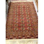 Bokhara rug decorated with three rows of nine gols on wine ground, approximately 60ins x 36ins