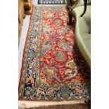 Indo Persian rug with stylised all-over design on red ground with borders, approximately 7ft x 4ft