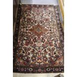 Small Saruq rug with a medallion and floral design on ivory ground with borders, 5ft x 3ft