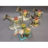 Four 19th Century Staffordshire figures of donkeys and a similar Majolica figure