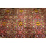 Afghan carpet with three rows of six gols on a wine ground with borders, 11ft x 7ft approximately