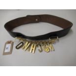 Moschino ladies leather belt with gilt metal hanging logo on chain